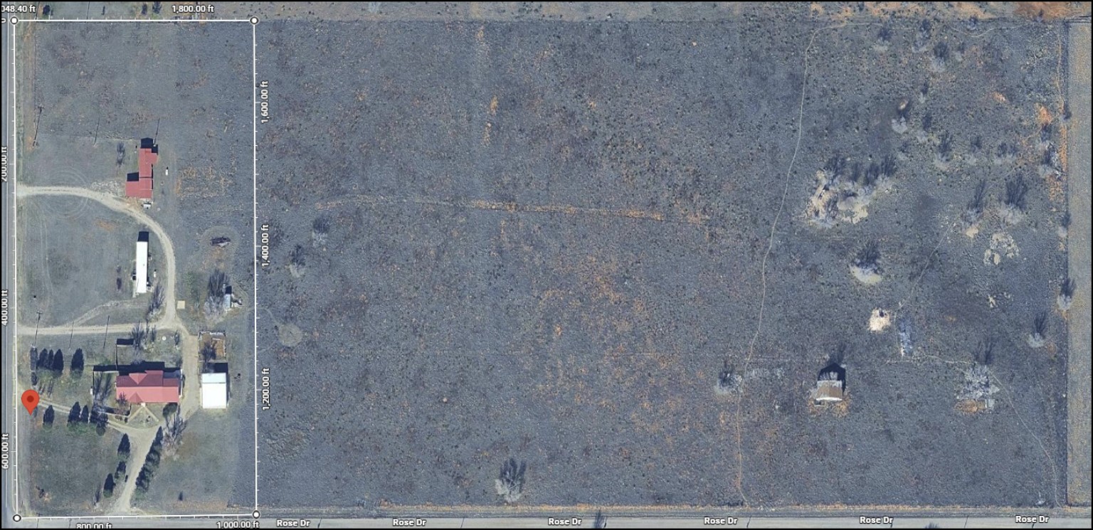 Aerial view showing homesite and adjoining acreage