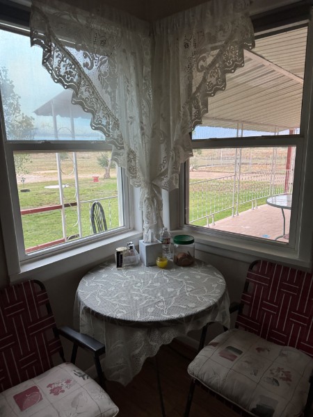 Breakfast table by kitchen windows overlooking the property